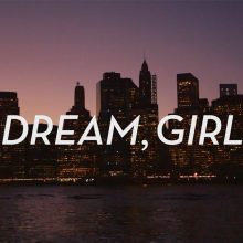 "Dream, Girl" written in white with a city landscape in the back during the night.